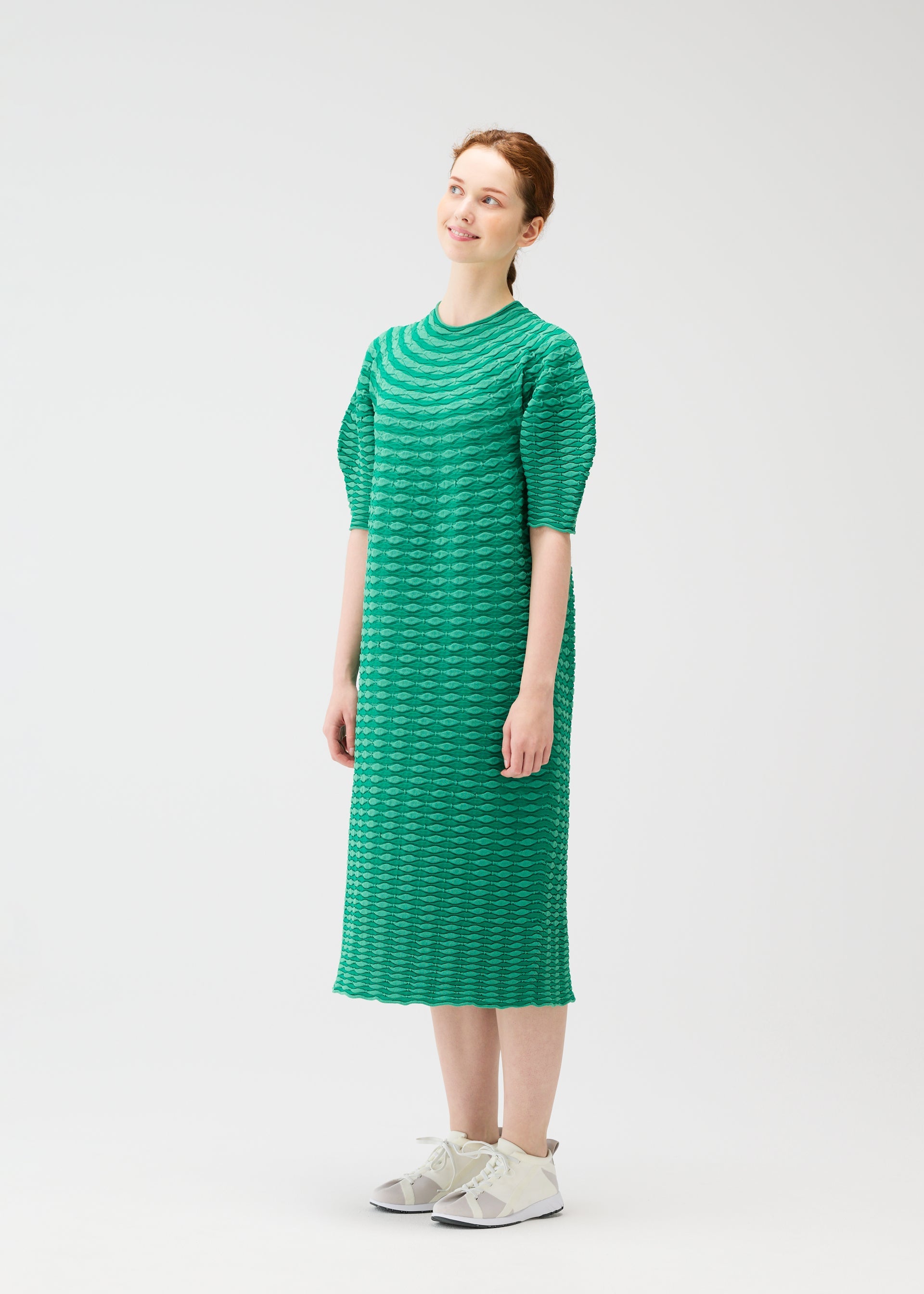 A model wears the PLEATS PLEASE ISSEY MIYAKE COLORFUL MUSHROOM KNIT dress.