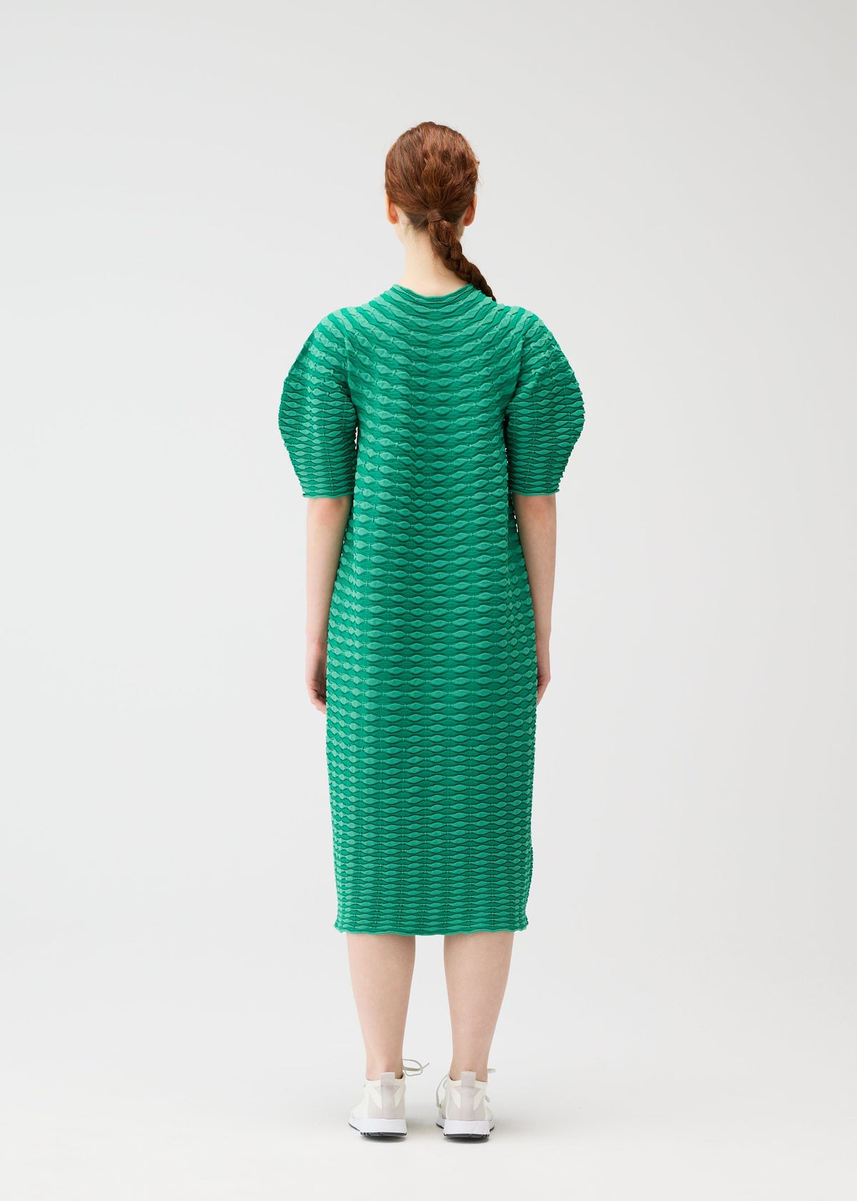 A model wears the PLEATS PLEASE ISSEY MIYAKE COLORFUL MUSHROOM KNIT dress.
