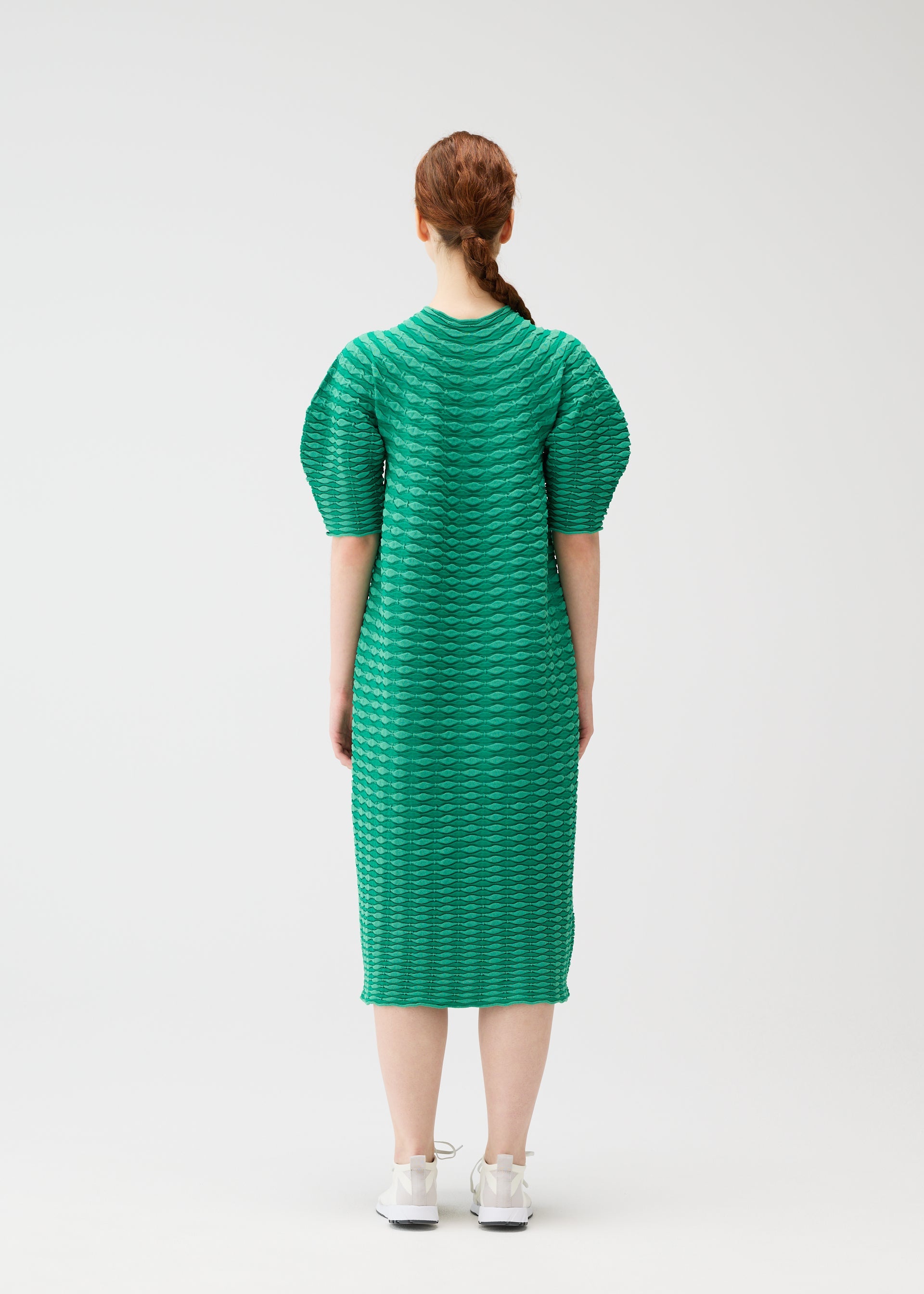 A model wears the PLEATS PLEASE ISSEY MIYAKE COLORFUL MUSHROOM KNIT dress.
