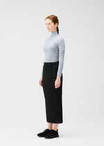 A model wears the PLEATS PLEASE ISSEY MIYAKE A POC SKIN shirt.
