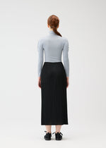 A model wears the PLEATS PLEASE ISSEY MIYAKE A POC SKIN shirt.