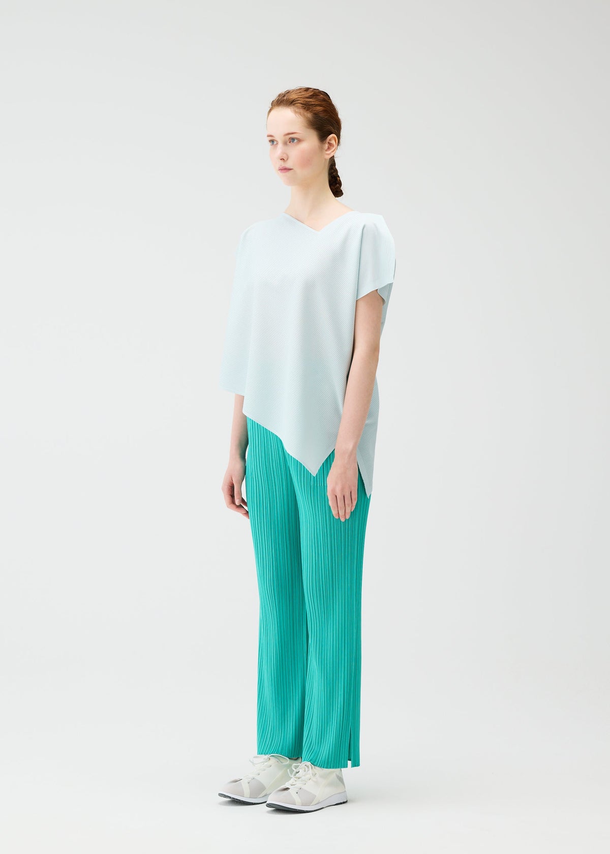 A model wears the PLEATS PLEASE ISSEY MIYAKE A POC SEA GLASS top.