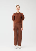 A model wears the PLEATS PLEASE ISSEY MIYAKE COLORFUL MUSHROOM KNIT shirt.