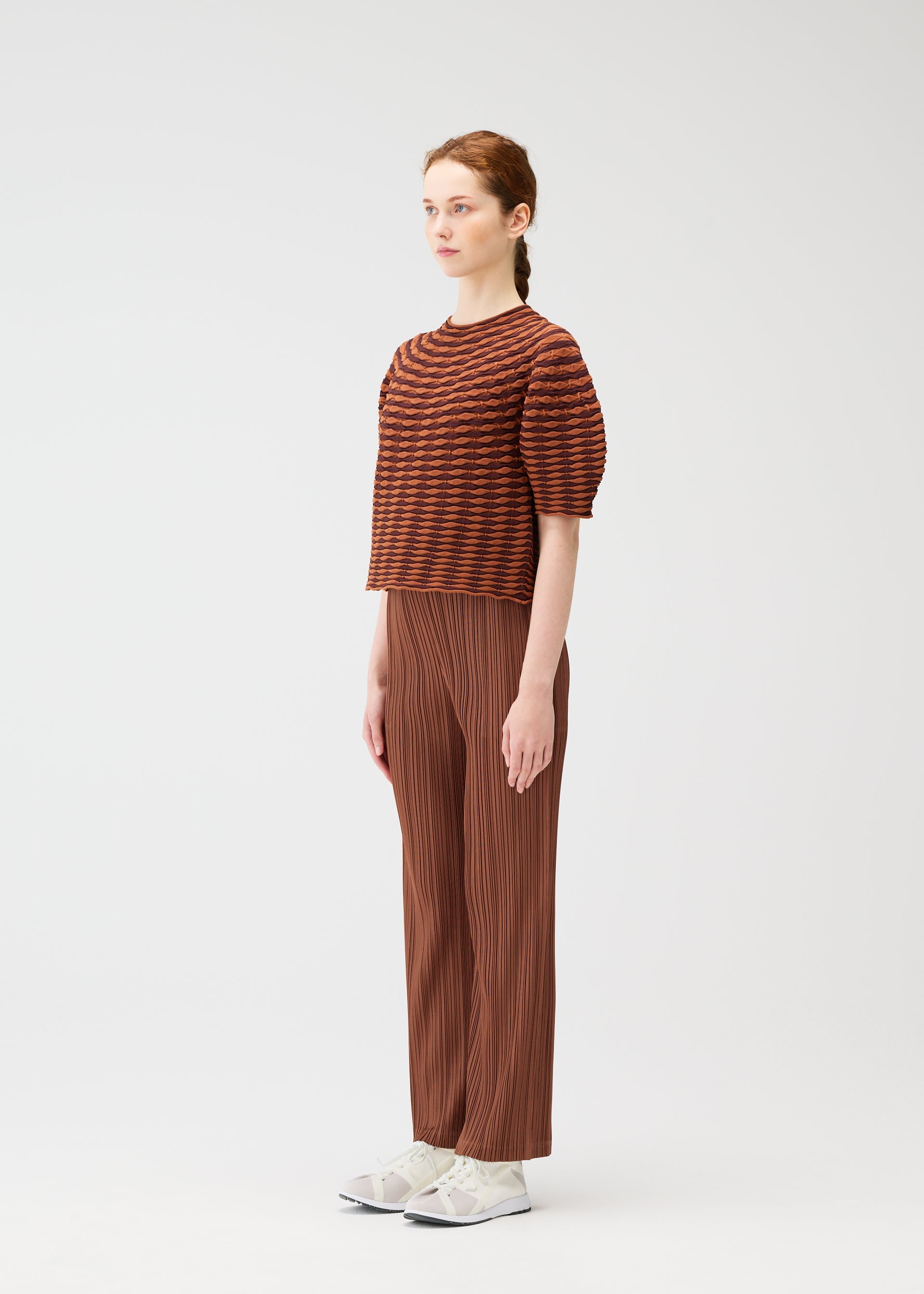 A model wears the PLEATS PLEASE ISSEY MIYAKE COLORFUL MUSHROOM KNIT shirt.