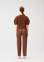 A model wears the PLEATS PLEASE ISSEY MIYAKE COLORFUL MUSHROOM KNIT shirt.