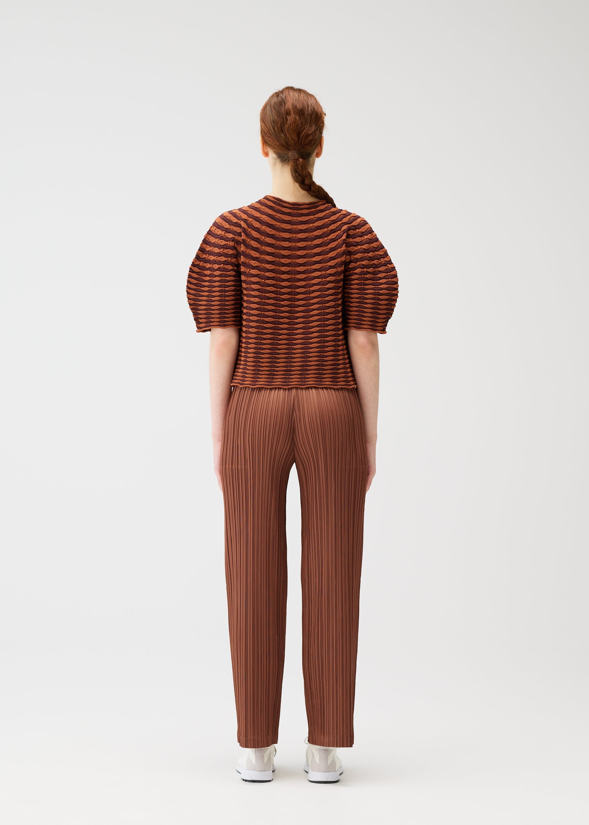 A model wears the PLEATS PLEASE ISSEY MIYAKE COLORFUL MUSHROOM KNIT shirt.