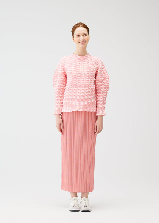 A model wears the PLEATS PLEASE ISSEY MIYAKE COLORFUL MUSHROOM KNIT shirt.