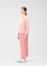 A model wears the PLEATS PLEASE ISSEY MIYAKE COLORFUL MUSHROOM KNIT shirt.