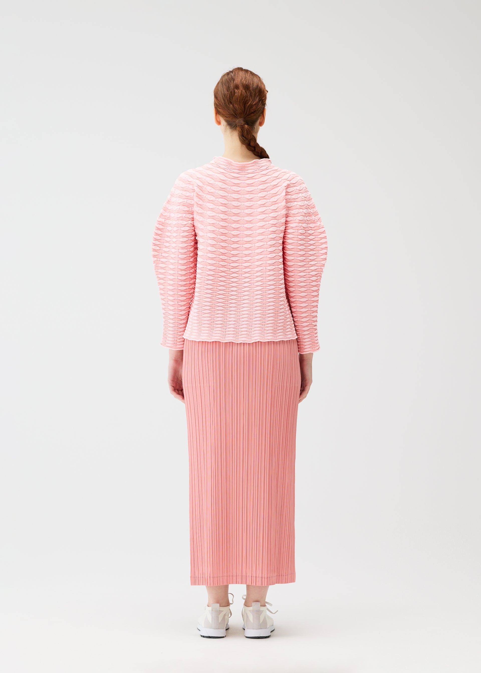 A model wears the PLEATS PLEASE ISSEY MIYAKE COLORFUL MUSHROOM KNIT shirt.