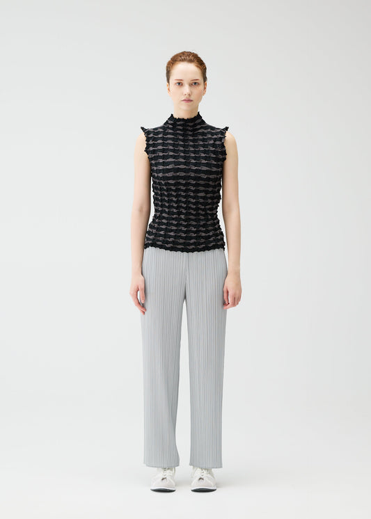 A model wears the PLEATS PLEASE ISSEY MIYAKE TWIST KNIT shirt.