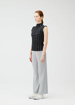 A model wears the PLEATS PLEASE ISSEY MIYAKE TWIST KNIT shirt.