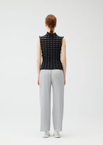 A model wears the PLEATS PLEASE ISSEY MIYAKE TWIST KNIT shirt.