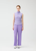 A model wears the PLEATS PLEASE ISSEY MIYAKE TWIST KNIT shirt.