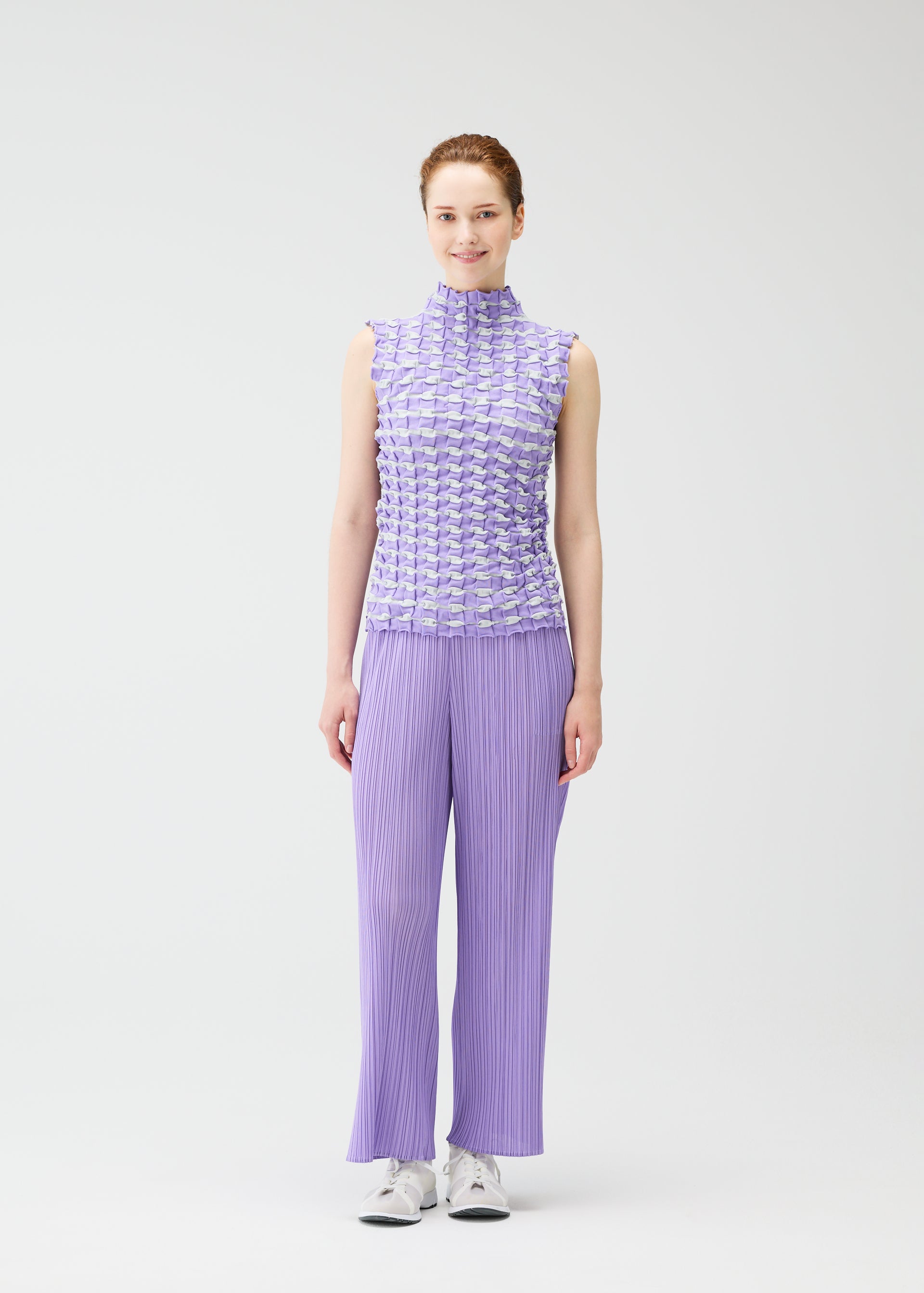 A model wears the PLEATS PLEASE ISSEY MIYAKE TWIST KNIT shirt.