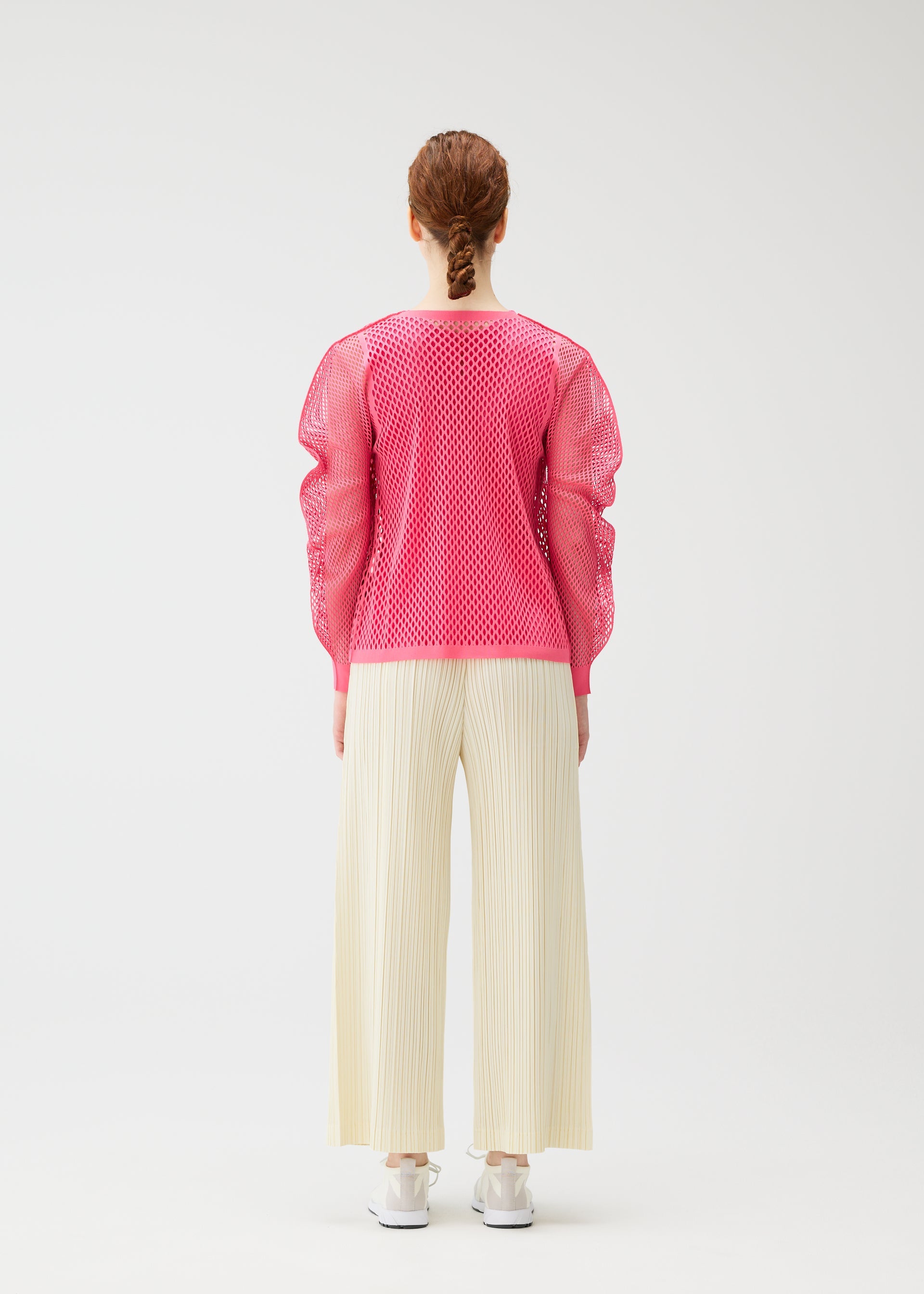 A model wears the PLEATS PLEASE ISSEY MIYAKE A-POC BASKET a-poc-basket-cardigan-off-white.