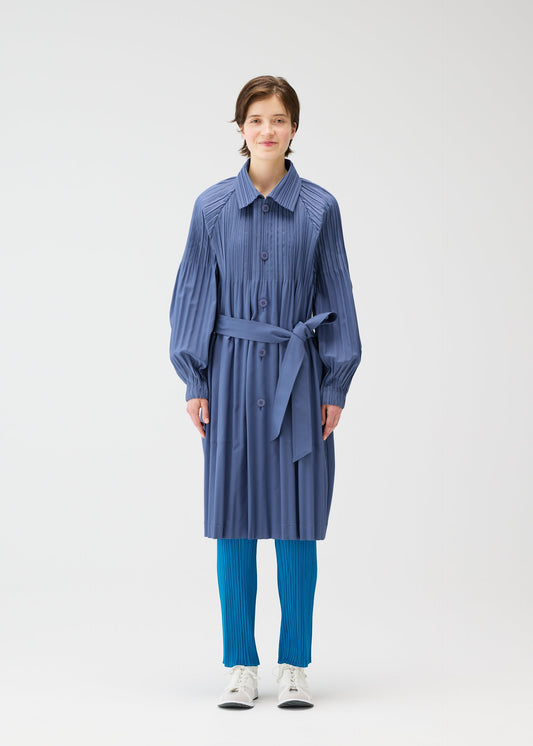 A model wears the PLEATS PLEASE ISSEY MIYAKE SMOOTH COAT coat.