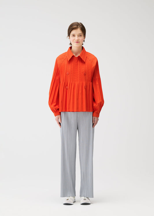 A model wears the PLEATS PLEASE ISSEY MIYAKE SMOOTH COAT coat.