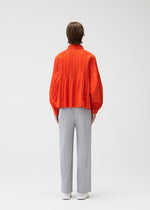 A model wears the PLEATS PLEASE ISSEY MIYAKE SMOOTH COAT coat.