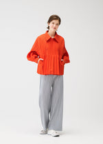 A model wears the PLEATS PLEASE ISSEY MIYAKE SMOOTH COAT coat.