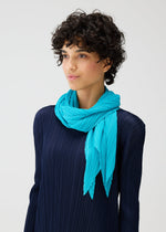 A model wears the PLEATS PLEASE ISSEY MIYAKE MONTHLY SCARF JANUARY accessories.