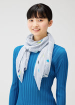 A model wears the PLEATS PLEASE ISSEY MIYAKE CROSSING DOTS SCARF stole.