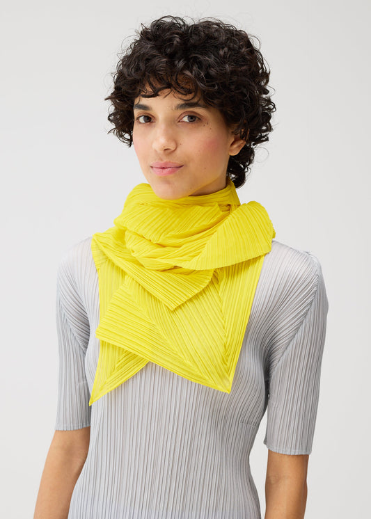 A model wears the PLEATS PLEASE ISSEY MIYAKE ZIGZAG SCARF stole.