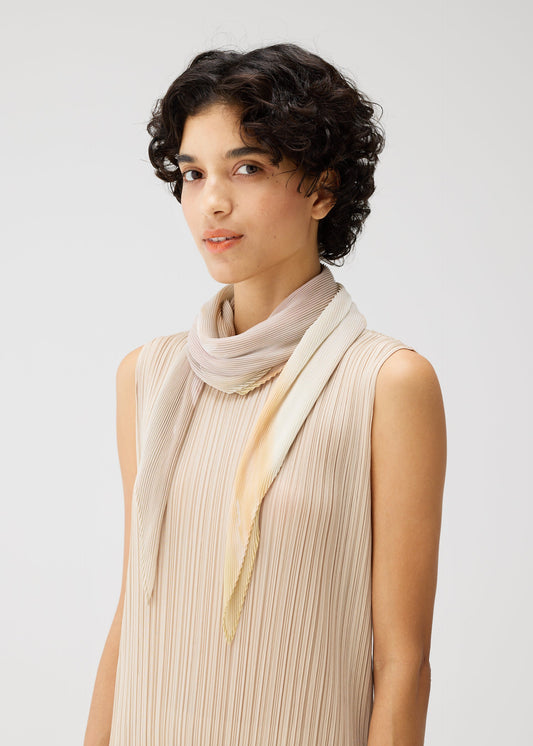 A model wears the PLEATS PLEASE ISSEY MIYAKE SEA BUBBLE SCARF stole.
