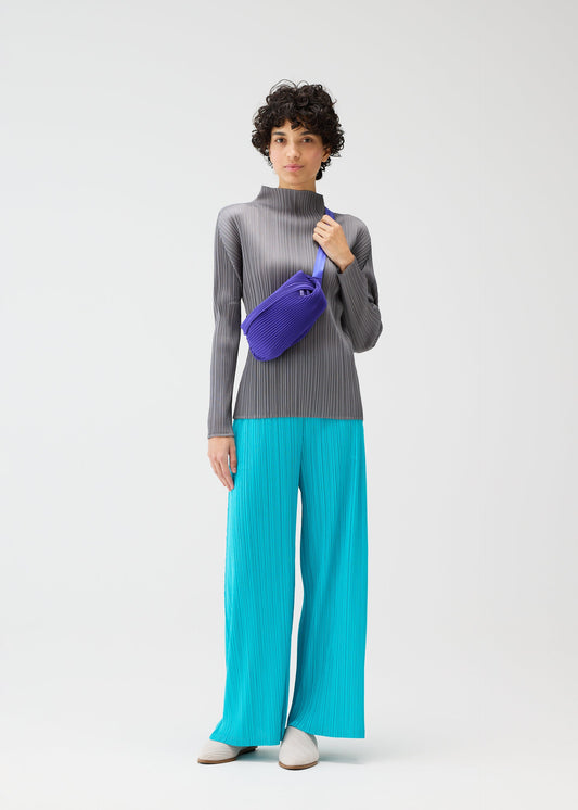 A model wears the PLEATS PLEASE ISSEY MIYAKE BIAS PLEATS WAIST BAG bags.