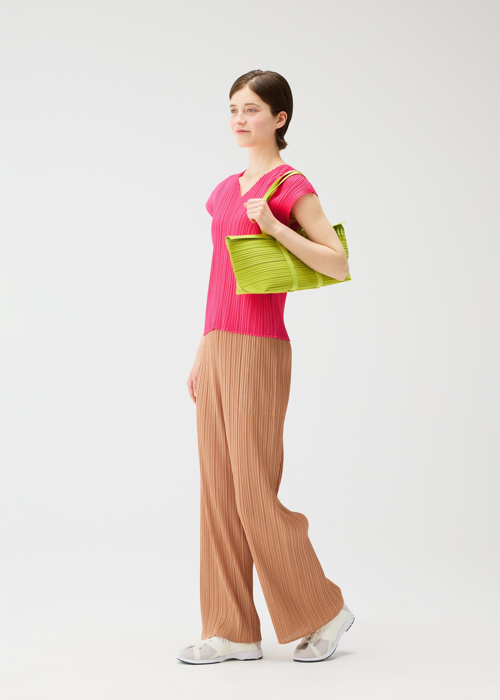 A model wears the PLEATS PLEASE ISSEY MIYAKE PLEATS BOSTON BAG pleats-boston-bag-bag-black-2.