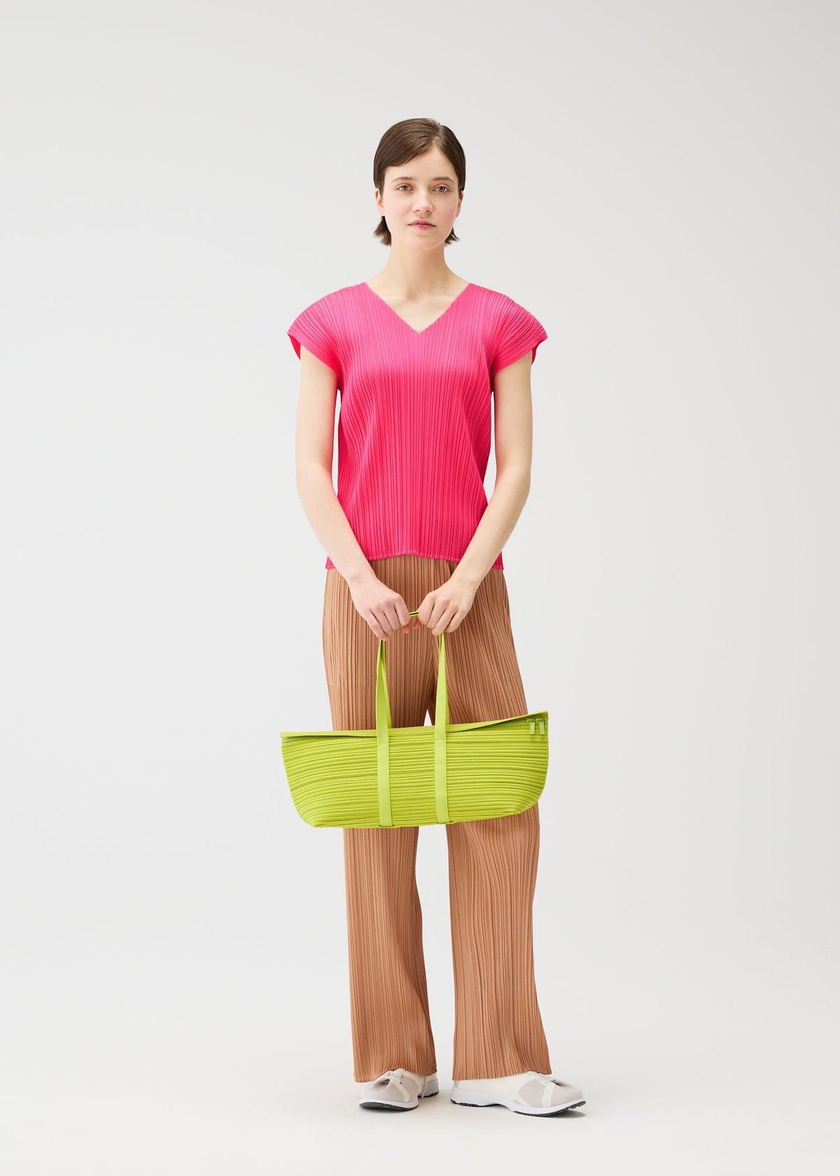 A model wears the PLEATS PLEASE ISSEY MIYAKE PLEATS BOSTON BAG pleats-boston-bag-bag-black-2.