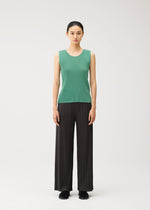 A model wears the PLEATS PLEASE ISSEY MIYAKE MIST AUGUST mist-august-top-greyish-green.