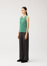A model wears the PLEATS PLEASE ISSEY MIYAKE MIST AUGUST mist-august-top-greyish-green.