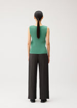 A model wears the PLEATS PLEASE ISSEY MIYAKE MIST AUGUST mist-august-top-greyish-green.