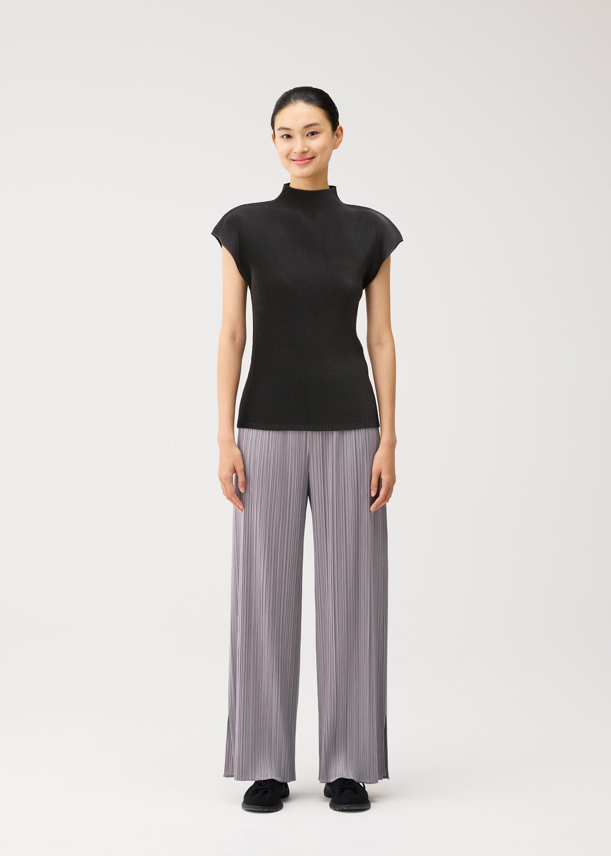 A model wears the PLEATS PLEASE ISSEY MIYAKE MIST AUGUST mist-august-cap-sleeved-high-neck-top-light-blue.