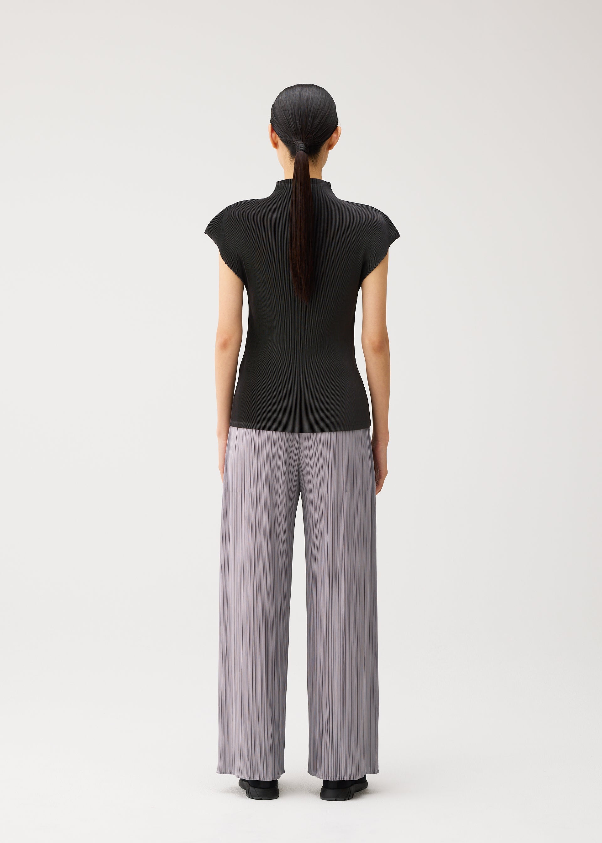 A model wears the PLEATS PLEASE ISSEY MIYAKE MIST AUGUST mist-august-cap-sleeved-high-neck-top-greyish-green.