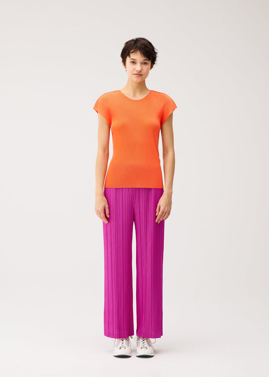 A model wears the PLEATS PLEASE ISSEY MIYAKE MIST SEPTEMBER mist-september-top-navy-2.