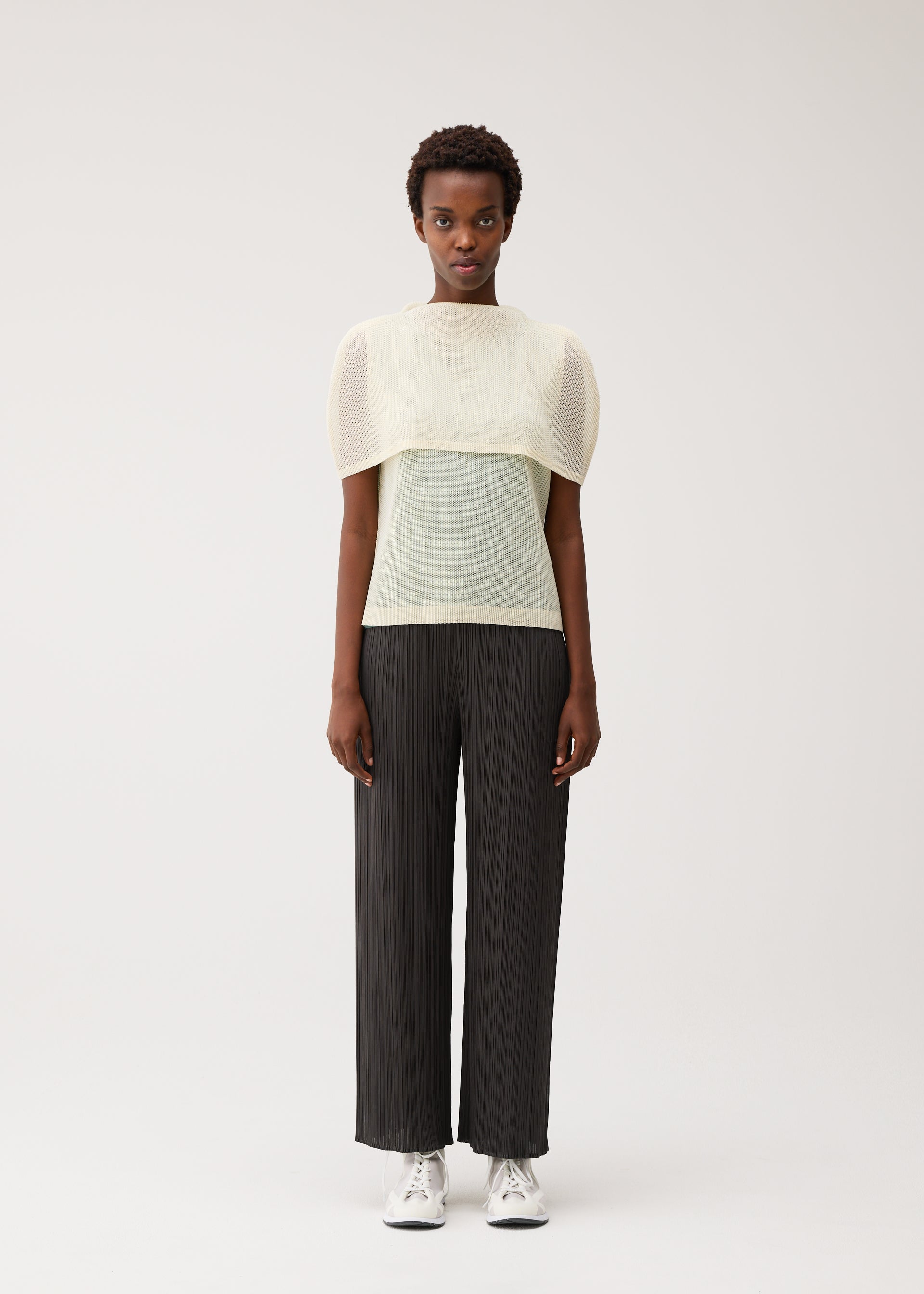 A model wears the PLEATS PLEASE ISSEY MIYAKE TATAMI AUGUST tatami-august-boat-neck-top-marine-blue.