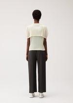 A model wears the PLEATS PLEASE ISSEY MIYAKE TATAMI AUGUST tatami-august-top-off-white.
