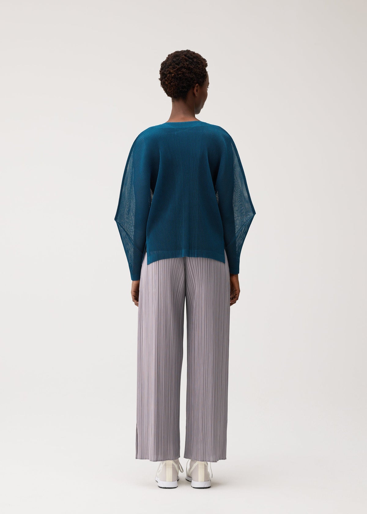 A model wears the PLEATS PLEASE ISSEY MIYAKE TATAMI AUGUST tatami-august-cardigan-off-white.
