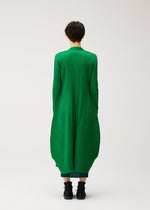 A model wears the PLEATS PLEASE ISSEY MIYAKE MONTHLY COLORS : OCTOBER monthly-colors-october-mid-length-coat-green.