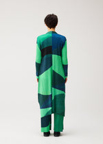 A model wears the PLEATS PLEASE ISSEY MIYAKE ORBIT orbit-coat-yellow.