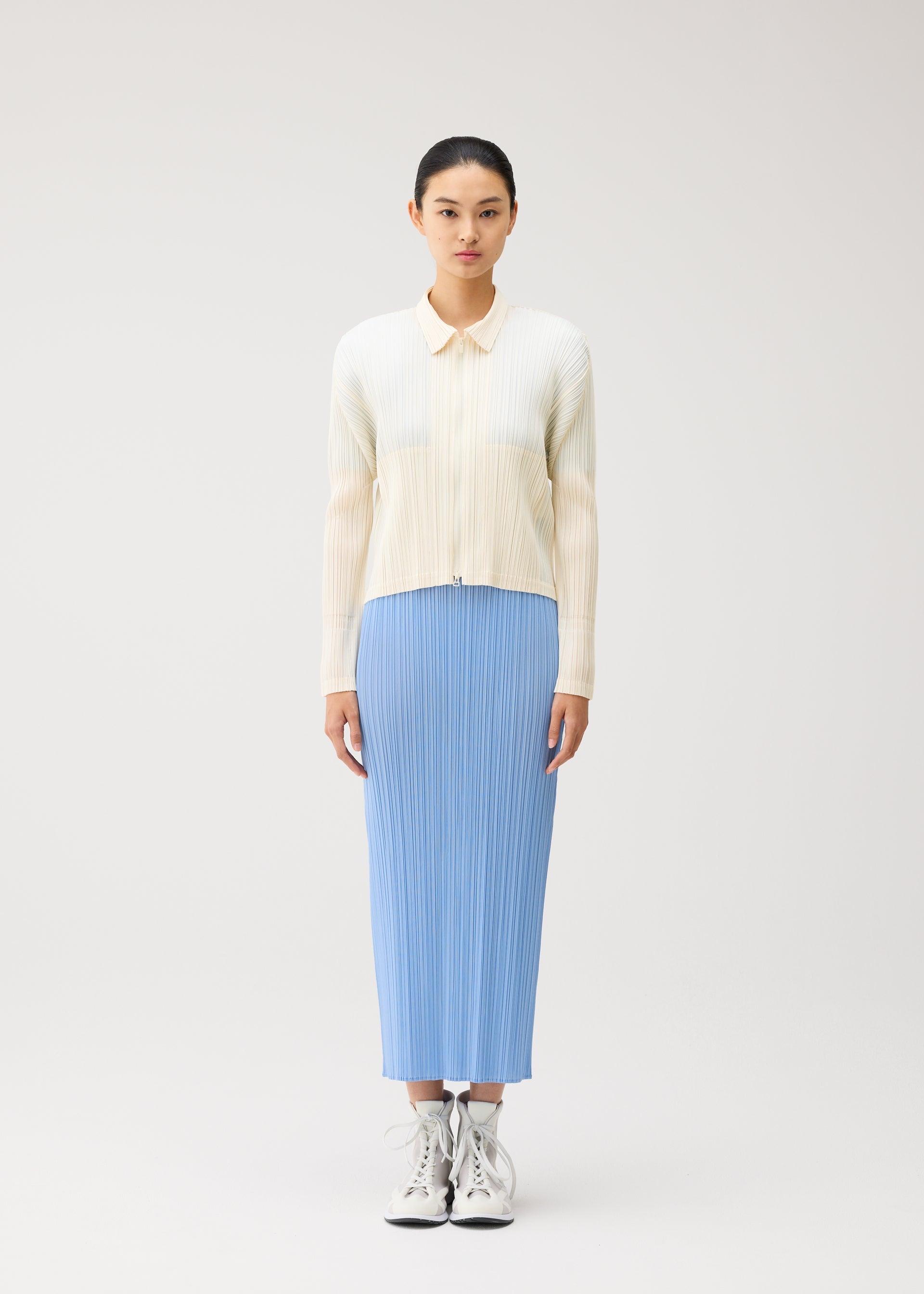 A model wears the PLEATS PLEASE ISSEY MIYAKE MONTHLY COLORS : AUGUST monthly-colors-august-jacket-light-blue.