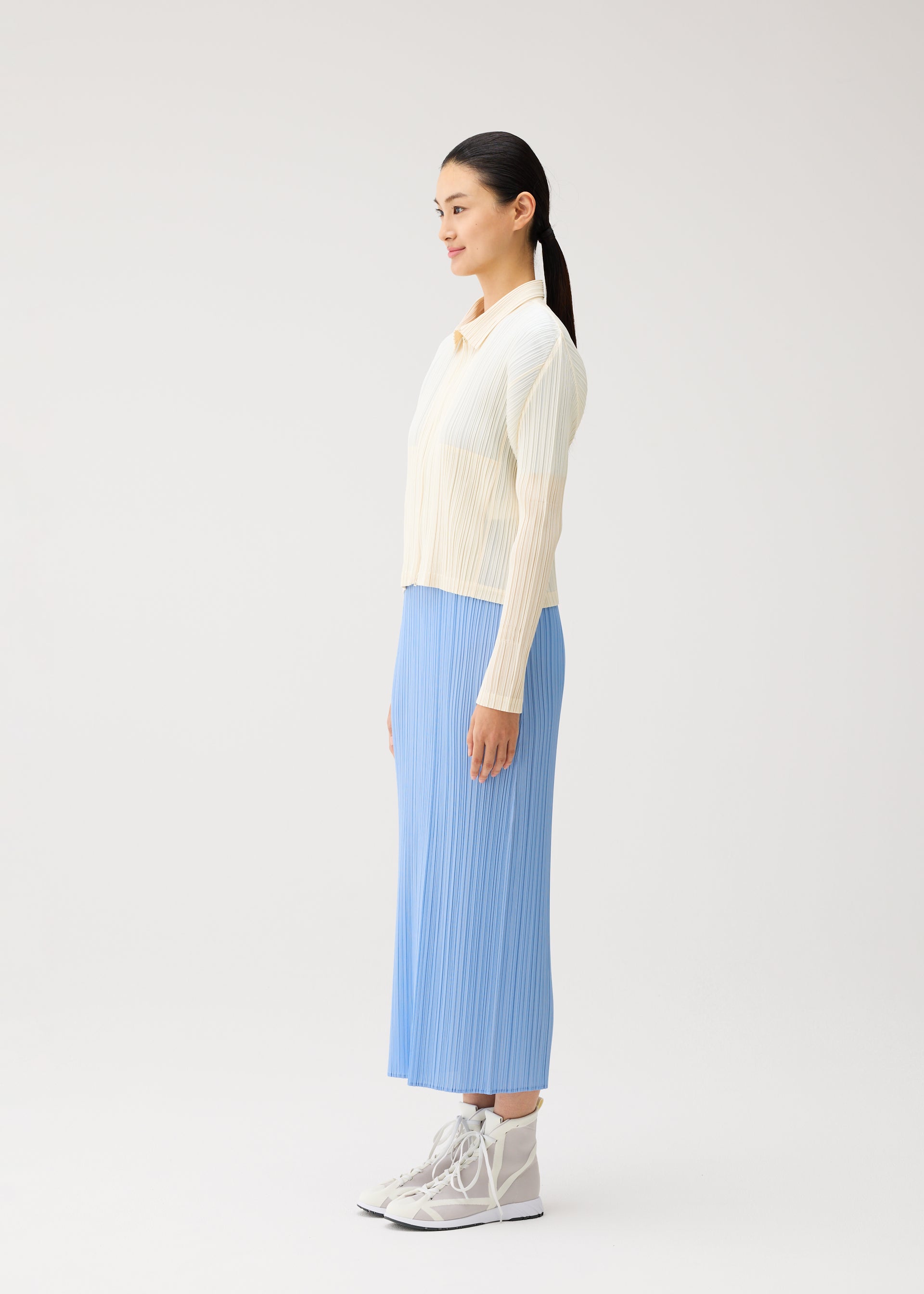 A model wears the PLEATS PLEASE ISSEY MIYAKE MONTHLY COLORS : AUGUST monthly-colors-august-jacket-light-blue.
