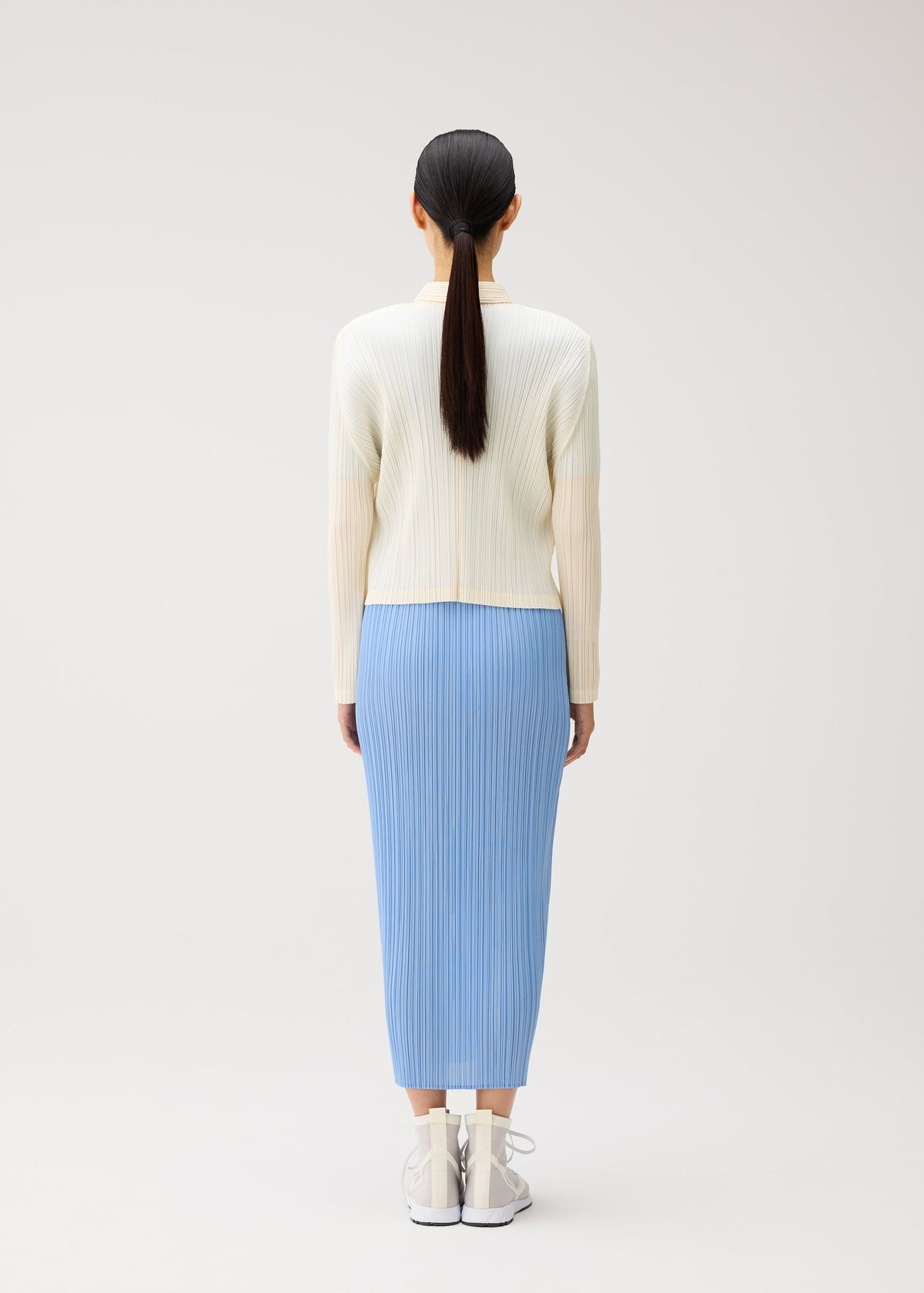 A model wears the PLEATS PLEASE ISSEY MIYAKE MONTHLY COLORS : AUGUST monthly-colors-august-jacket-light-blue.