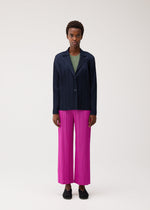 A model wears the PLEATS PLEASE ISSEY MIYAKE PLEATS JACKET pleats-jacket-jacket-charcoal.