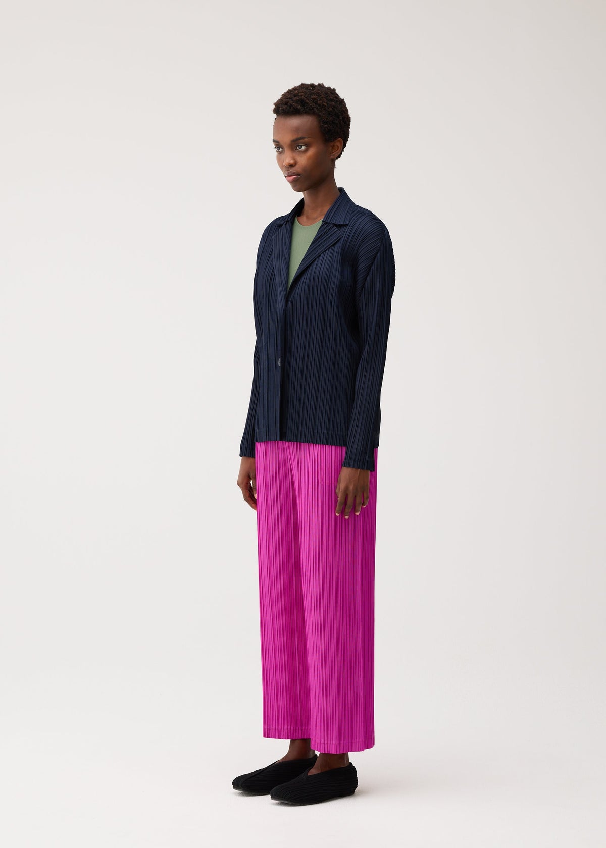A model wears the PLEATS PLEASE ISSEY MIYAKE PLEATS JACKET pleats-jacket-jacket-charcoal.
