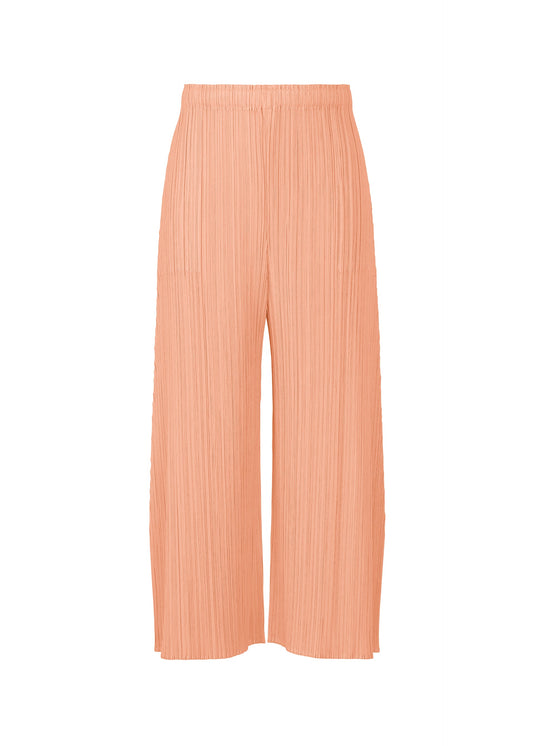 A product shot of the PLEATS PLEASE ISSEY MIYAKE MONTHLY COLORS : JULY trousers in pale orange.