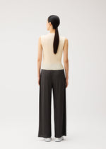 A model wears the PLEATS PLEASE ISSEY MIYAKE MONTHLY COLORS : AUGUST monthly-colors-august-trousers-greyish-green.