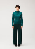 A model wears the PLEATS PLEASE ISSEY MIYAKE MONTHLY COLORS : OCTOBER monthly-colors-october-wide-leg-trousers-ash-beige.