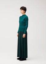 A model wears the PLEATS PLEASE ISSEY MIYAKE MONTHLY COLORS : OCTOBER monthly-colors-october-wide-leg-trousers-ash-beige.